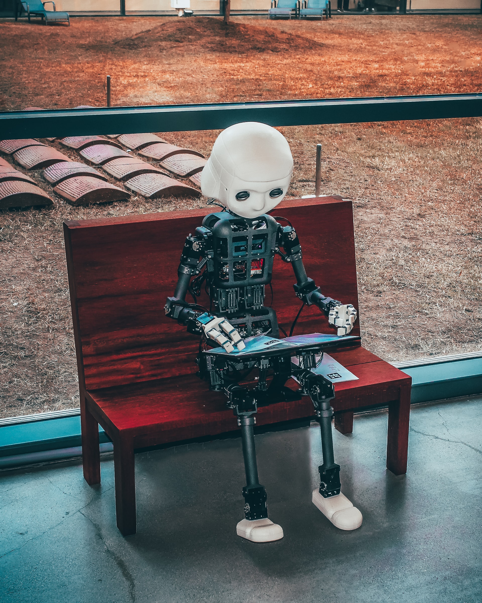 robot sitting on a bench alone