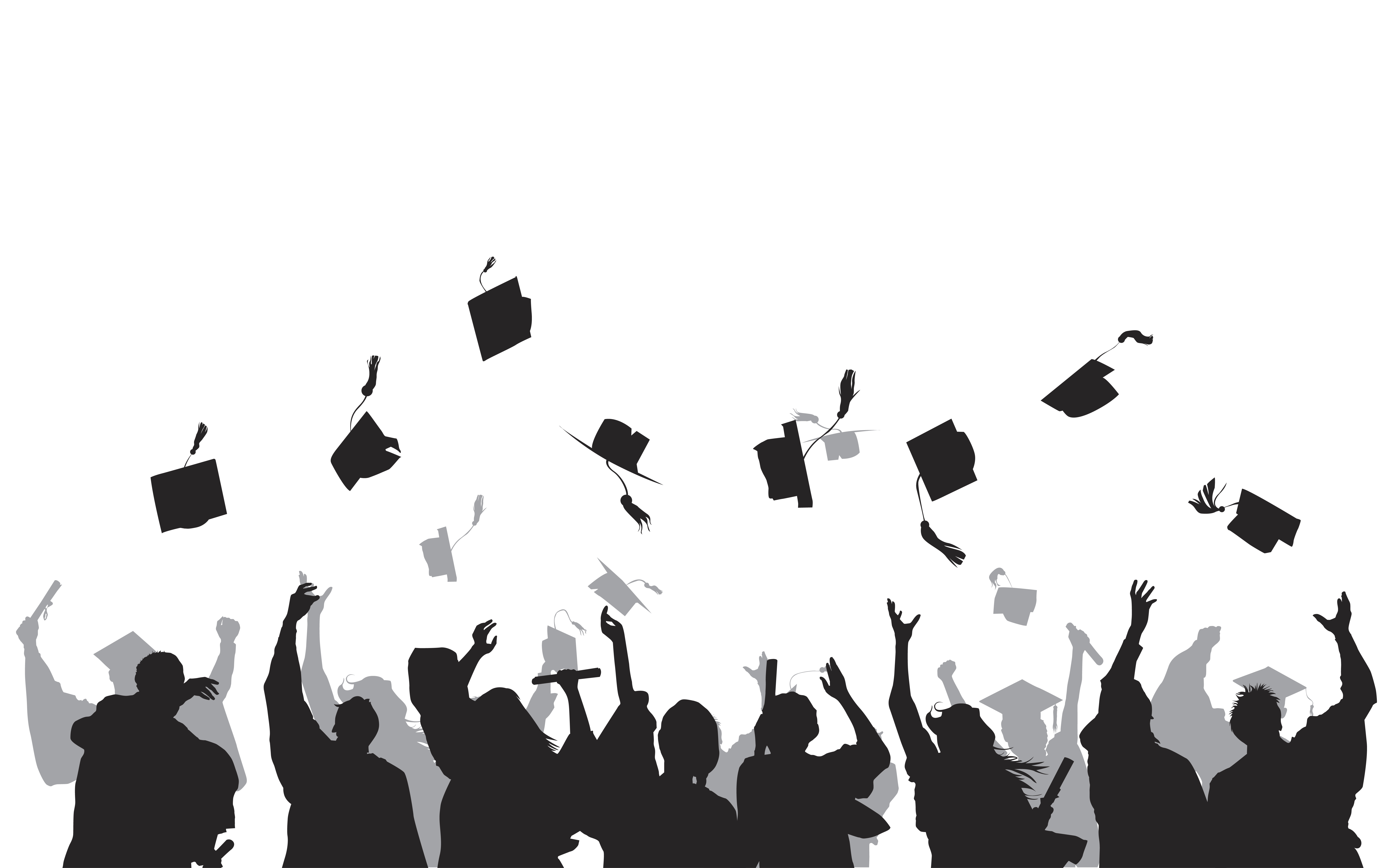 students throwing their graduation caps into the air